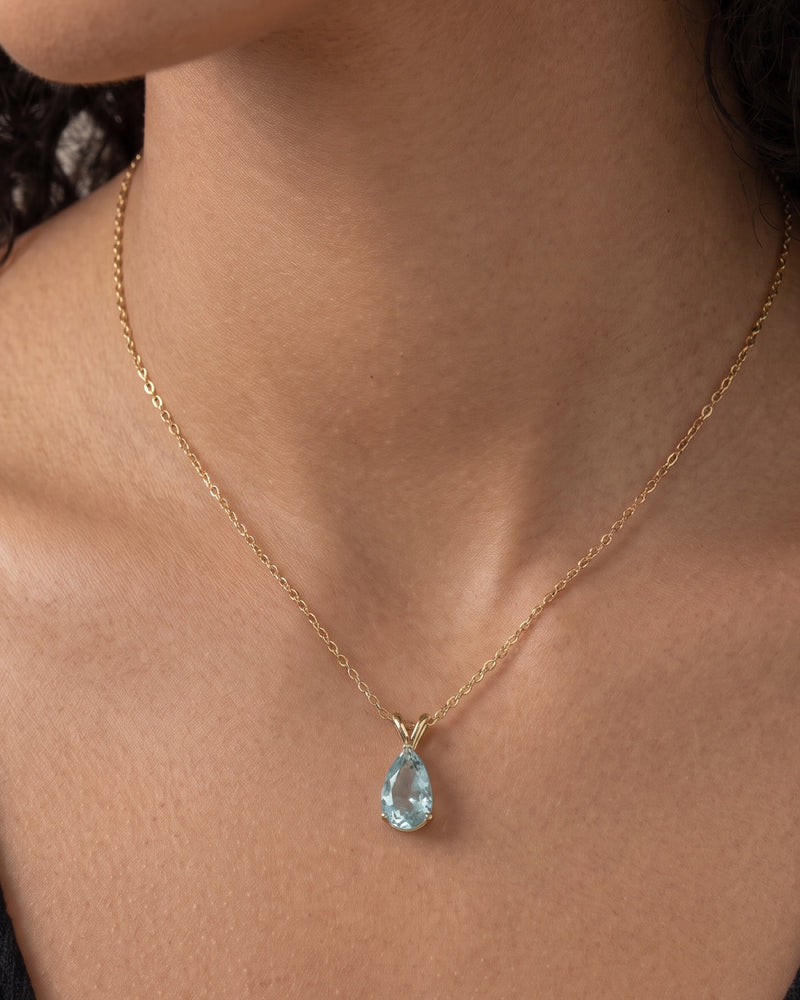 Collier Azur Bellurr porté, pendentif goutte bleu ciel sur chaîne fine dorée